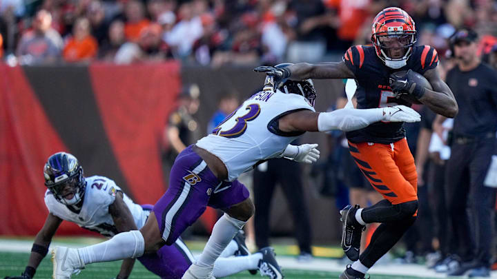 Cincinnati Bengals wide receiver Tee Higgins (5) breaks tackles on a reception in the fourth quarter of the NFL Week 5 game between the Cincinnati Bengals and Baltimore Ravens at Paycor Stadium in downtown Cincinnati on Sunday, Oct. 6, 2024. The Bengals fell to 1-4 on the season with a 41-38 loss to the Ravens.