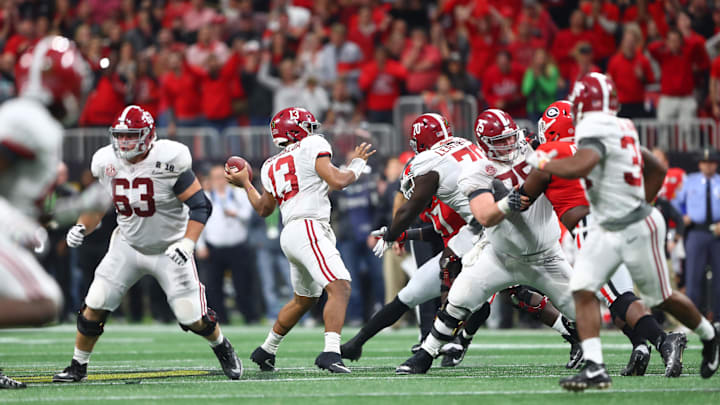 Jan 8, 2018; Atlanta, GA, USA; Alabama Crimson Tide quarterback Tua Tagovailoa (13) throws the game-winning touchdown pass to wide receiver DeVonta Smith (not pictured) in overtime against the Georgia Bulldogs in the 2018 CFP national championship college football game at Mercedes-Benz Stadium. Mandatory Credit: Mark J. Rebilas-Imagn Images