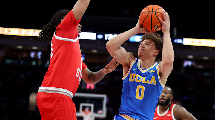 Jan 17, 2026; Columbus, Ohio, USA; UCLA Bruins guard Trent Perry (0) shoots the ball as Ohio State Buckeyes forward Devin Royal (21) defends during the first half at Value City Arena. Mandatory Credit: Joseph Maiorana-Imagn Images
