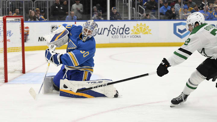 Jan 25, 2025; St. Louis, Missouri, USA; St. Louis Blues goaltender Jordan Binnington (50) defends the net from Dallas Stars center Mavrik Bourque (22) during the third period at Enterprise Center. Mandatory Credit: Jeff Le-Imagn Images