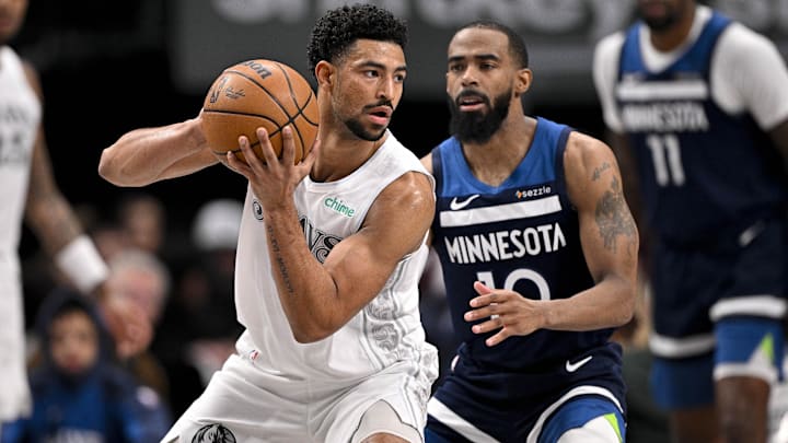 Dallas Mavericks guard Quentin Grimes looks to move the ball past Minnesota Timberwolves guard Mike Conley during the first half at the American Airlines Center in Dallas on Jan. 22, 2025.