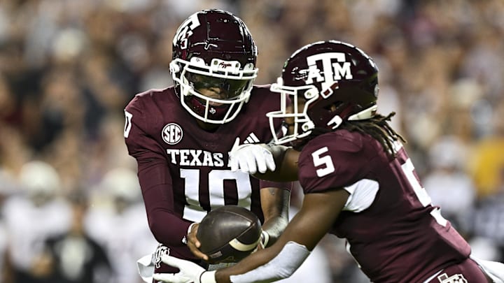 Nov 16, 2024; College Station, Texas, USA; Texas A&M Aggies quarterback Marcel Reed (10) hands off the ball during the first quarter against the New Mexico State Aggies at Kyle Field.