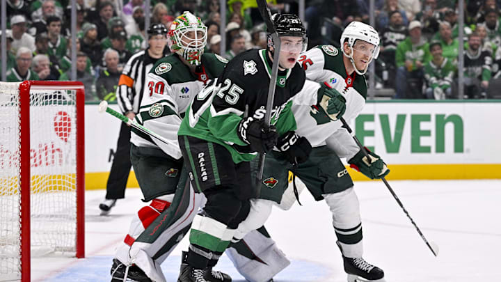 Apr 20, 2026; Dallas, Texas, USA; Minnesota Wild goaltender Jesper Wallstedt (30) and defenseman Jonas Brodin (25) and Dallas Stars right wing Arttu Hyry (25) look for the puck during the second period in game two of the first round of the 2026 Stanley Cup Playoffs at American Airlines Center. Mandatory Credit: Jerome Miron-Imagn Images