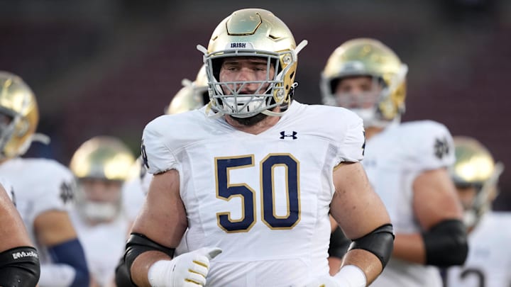 Nov 27, 2021; Stanford, California, USA; Notre Dame Fighting Irish offensive lineman Rocco Spindler (50) jogs on the field before the game against the Stanford Cardinal at Stanford Stadium. Mandatory Credit: Darren Yamashita-Imagn Images