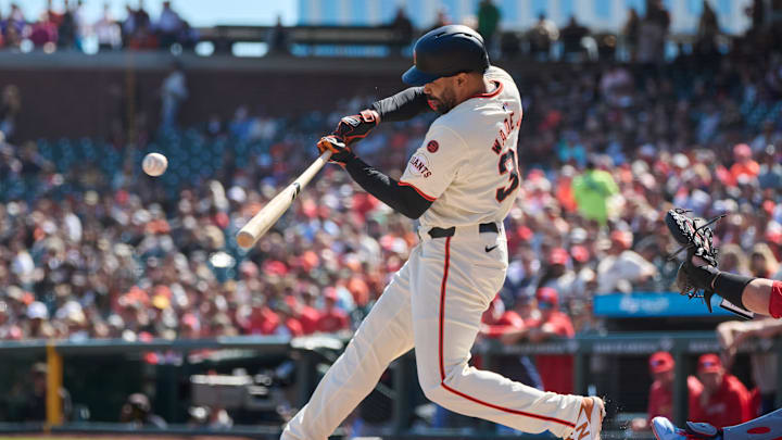 Sep 28, 2024; San Francisco, California, USA; San Francisco Giants infielder LaMonte Wade Jr. (31) hits an RBI single against the St. Louis Cardinals during the first inning at Oracle Park.