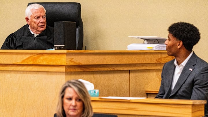 Lafayette County Chancery Court Judge Robert Whitwell, left, questions Ole Miss quarterback Trinidad Chambliss, right, during the hearing in his lawsuit against the NCAA at Calhoun County Courthouse in Pittsboro, Miss., on Thursday, Feb. 12, 2026. Chambliss is looking for a temporary injunction and a permanent injunction against the NCAA for one more year of eligibility.