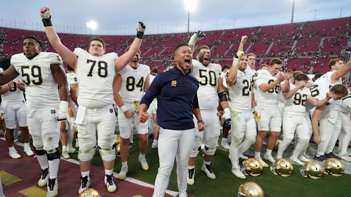 Nov 30, 2024; Los Angeles, California, USA; Notre Dame Fighting Irish head coach Marcus Freeman celebrates with players at the end of the game against the Southern California Trojans at United Airlines Field at Los Angeles Memorial Coliseum. Nov 30, 2024; Los Angeles, California, USA; Notre Dame Fighting Irish head coach Marcus Freeman celebrates with players at the end of the game against the Southern California Trojans at United Airlines Field at Los Angeles Memorial Coliseum.
