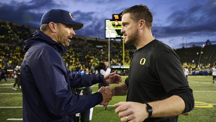 Nov 4, 2023; Eugene, Oregon, USA; California Golden Bears head coach Justin Wilcox, left, shakes hands with Oregon Ducks head coach Dan Lanning after a game at Autzen Stadium. Mandatory Credit: Troy Wayrynen-Imagn Images