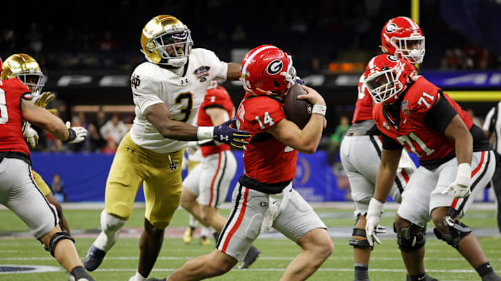 Jan 2, 2025; New Orleans, LA, USA; Georgia Bulldogs quarterback Gunner Stockton (14) runs with the ball during the second half against Notre Dame Fighting Irish running back Gi'Bran Payne (3) at Caesars Superdome.