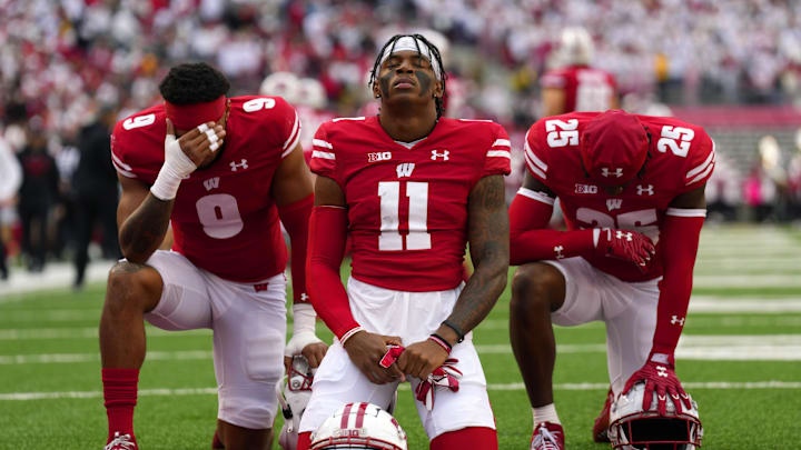 Oct 14, 2023; Madison, Wisconsin, USA;  Wisconsin Badgers wide receiver Skyler Bell (11) kneels prior to the game against the Iowa Hawkeyes at Camp Randall Stadium. Mandatory Credit: Jeff Hanisch-Imagn Images