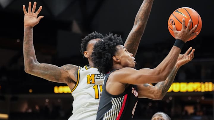 Jan 20, 2026; Columbia, Missouri, USA; Georgia Bulldogs guard Marcus Millender (4) shoots the game winning layup as Missouri Tigers center Shawn Phillips Jr. (15) defends during the second half of the game at Mizzou Arena. Mandatory Credit: Denny Medley-Imagn Images