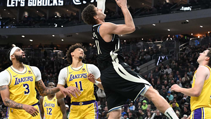 Mar 26, 2024; Milwaukee, Wisconsin, USA; Milwaukee Bucks center Brook Lopez (11) puts up a shot against /l11. int the first half at Fiserv Forum. Mandatory Credit: Michael McLoone-Imagn Images
