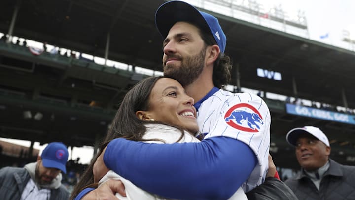 Chicago Cubs shortstop Dansby Swanson hugs his wife, Chicago Stars forward Mallory Swanson, on opening day at Wrigley Field on March 30, 2023, in Chicago.