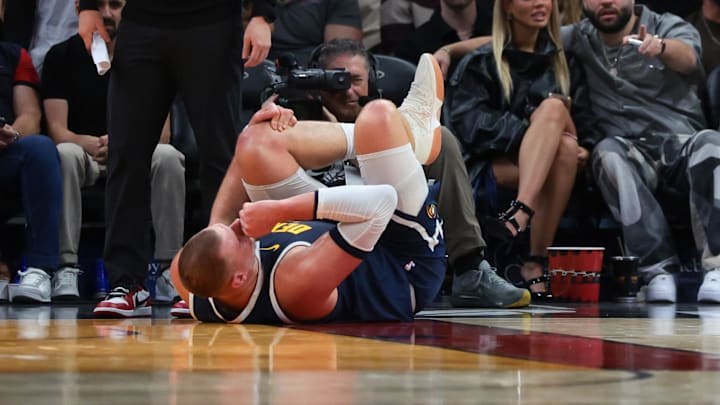 Dec 29, 2025; Miami, Florida, USA; Denver Nuggets center Nikola Jokic (15) holds his knee after an injury against the Miami Heat during the second quarter at Kaseya Center. Mandatory Credit: Sam Navarro-Imagn Images Dec 29, 2025; Miami, Florida, USA; Denver Nuggets center Nikola Jokic (15) holds his knee after an injury against the Miami Heat during the second quarter at Kaseya Center. Mandatory Credit: Sam Navarro-Imagn Images