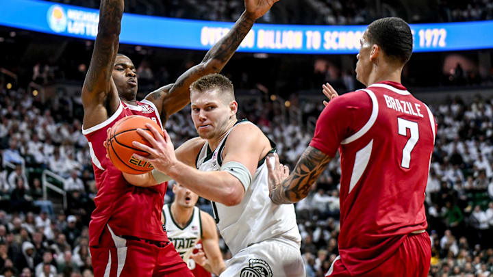 Michigan State's Jaxon Kohler, center, looks for room between Arkansas' Nick Pringle, left, and Trevon Brazile during the first half on Saturday, Nov. 8, 2025, at the Breslin Center in East Lansing. Michigan State's Jaxon Kohler, center, looks for room between Arkansas' Nick Pringle, left, and Trevon Brazile during the first half on Saturday, Nov. 8, 2025, at the Breslin Center in East Lansing.