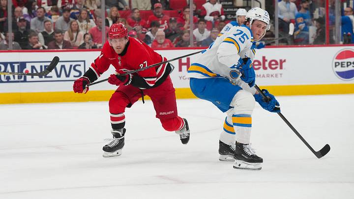 Mar 12, 2026; Raleigh, North Carolina, USA;  Carolina Hurricanes left wing Nikolaj Ehlers (27) and St. Louis Blues defenseman Tyler Tucker (75) watch the puck during the first period at Lenovo Center. Mandatory Credit: James Guillory-Imagn Images
