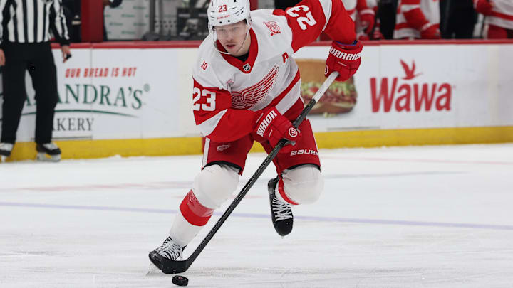 Detroit Red Wings ' Lucas Raymond, skating with the puck earlier this season, ranks No. 90 in shots on goal this season. Coach Todd McLellan wants the high-scoring right wing to shoot the puck more.