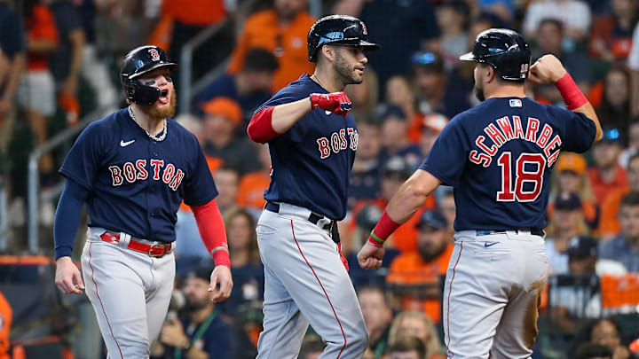 Oct 16, 2021; Houston, Texas, USA; Boston Red Sox designated hitter J.D. Martinez (28) is congratulated by first baseman Kyle Schwarber (18) and left fielder Alex Verdugo (99) after hitting a grand slam against the Houston Astros during the first inning in game two of the 2021 ALCS at Minute Maid Park. Mandatory Credit: Thomas Shea-Imagn Images
