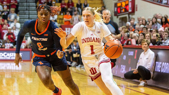 Indiana's Lexus Bargesser (1) drives on Illinois Jasmine Brown-Hagger (8) during the Indiana versus Illinois women's basketball game at Simon Skjodt Assembly Hall on Thursday, Jan. 16, 2025.