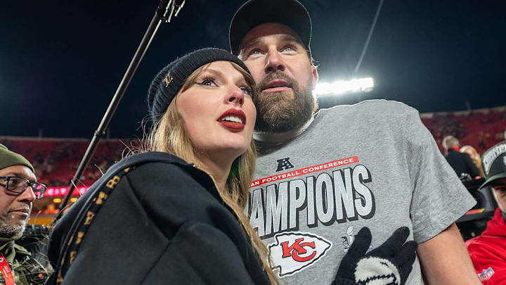 Taylor Swift, left, and Kansas City Chiefs tight end Travis Kelce walk off the field after the trophy ceremony following the Chiefs 32-29 victory over the Buffalo Bills in the AFC Championship Game.