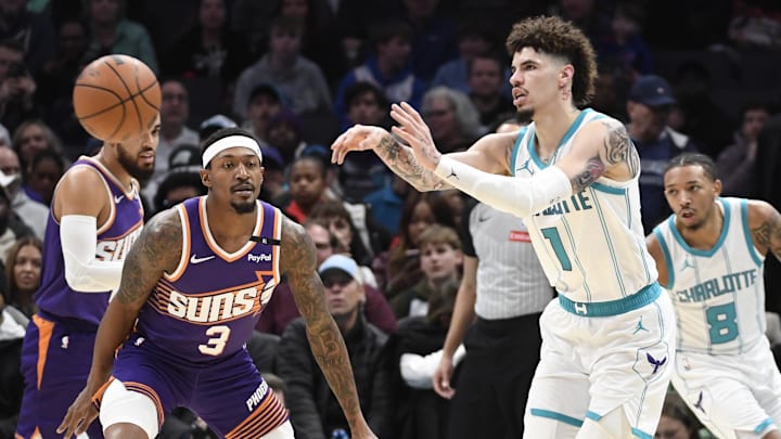 Jan 7, 2025; Charlotte, North Carolina, USA;  Charlotte Hornets guard LaMelo Ball (1) passes during the second half against the Phoenix Suns at the Spectrum Center. Mandatory Credit: Sam Sharpe-Imagn Images