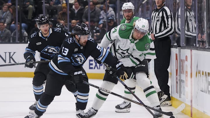 Jan 15, 2026; Salt Lake City, Utah, USA; Utah Mammoth left wing Michael Carcone (53) and Dallas Stars center Roope Hintz (24) battle for the puck during the third period at Delta Center. Mandatory Credit: Rob Gray-Imagn Images
