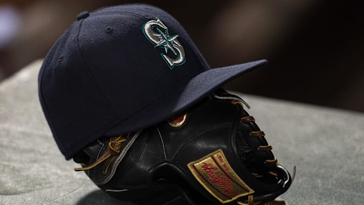 A Seattle Mariners hat and glove is pictured before a game against the Texas Rangers on April 27, 2015, at Globe Life Field.