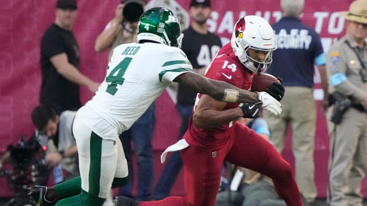 Arizona Cardinals wide receiver Michael Wilson (14) is tackled by New York Jets cornerback D.J. Reed (4) after a catch during the third quarter at State Farm Stadium in Glendale on Nov. 10, 2024.