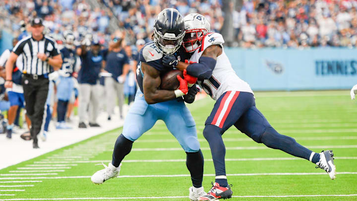 Nov 3, 2024; Nashville, Tennessee, USA; New England Patriots cornerback Jonathan Jones (31) tackles Tennessee Titans tight end Chigoziem Okonkwo (85) after a made catch during the second half at Nissan Stadium. Nov 3, 2024; Nashville, Tennessee, USA; New England Patriots cornerback Jonathan Jones (31) tackles Tennessee Titans tight end Chigoziem Okonkwo (85) after a made catch during the second half at Nissan Stadium.
