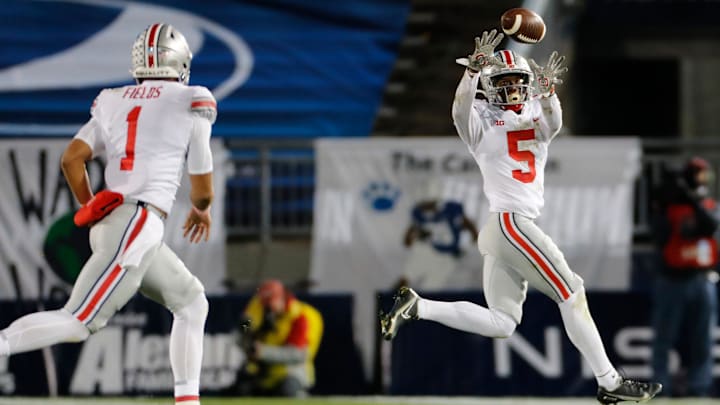 Ohio State Buckeyes quarterback Justin Fields (1) throws a pass to wide receiver Garrett Wilson (5) during the NCAA football game at Beaver Stadium in University Park, Pa. on Sunday, Nov. 1, 2020. Ohio State Buckeyes quarterback Justin Fields (1) throws a pass to wide receiver Garrett Wilson (5) during the NCAA football game at Beaver Stadium in University Park, Pa. on Sunday, Nov. 1, 2020.