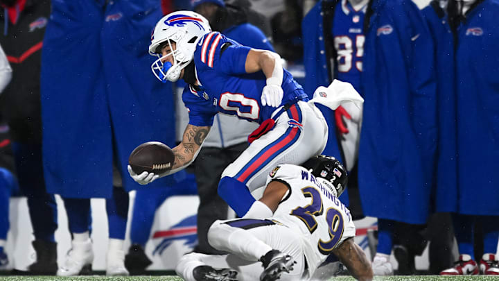 Jan 19, 2025; Orchard Park, New York, USA; Buffalo Bills wide receiver Khalil Shakir (10) tries to break a tackle by Baltimore Ravens safety Ar'Darius Washington (29) in the third quarter of a 2025 AFC divisional round game