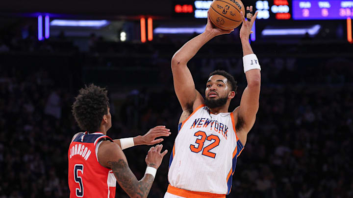 Mar 22, 2025; New York, New York, USA; New York Knicks center Karl-Anthony Towns (32) looks to pass as Washington Wizards guard AJ Johnson (5) defends during the first half at Madison Square Garden. Mandatory Credit: Vincent Carchietta-Imagn Images