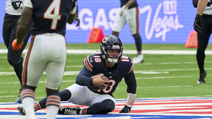 Oct 13, 2024; London, United Kingdom; Chicago Bears quarterback Caleb Williams (18) carries the ball for a first down during the first half of an NFL International Series game at Tottenham Hotspur Stadium. Mandatory Credit: Peter van den Berg-Imagn Images
