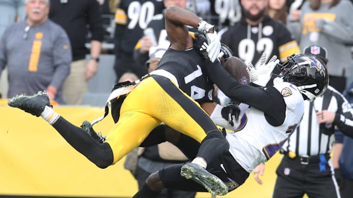 Nov 17, 2024; Pittsburgh, Pennsylvania, USA;  Baltimore Ravens cornerback Tre'Davious White (25) breaks up a pass in the end-zone intended for Pittsburgh Steelers wide receiver George Pickens (14) during the fourth quarter at Acrisure Stadium. Mandatory Credit: Charles LeClaire-Imagn Images