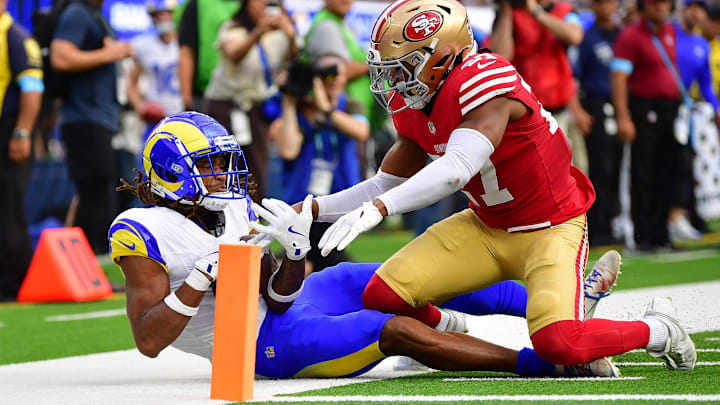 Sep 22, 2024; Inglewood, California, USA; Los Angeles Rams wide receiver Demarcus Robinson (15) catches the ball short of the goal line against San Francisco 49ers safety Ji'Ayir Brown (27) during the second half at SoFi Stadium. Mandatory Credit: Gary A. Vasquez-Imagn Images