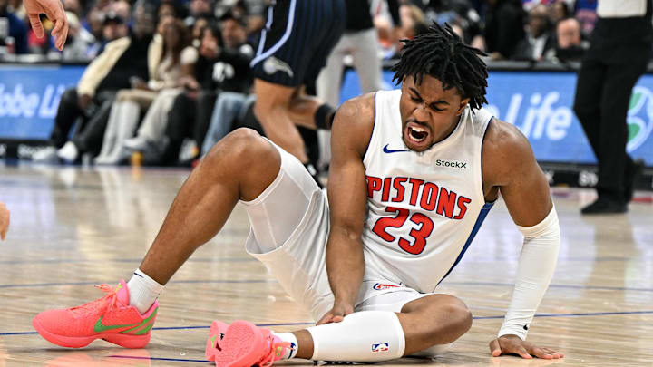 Jan 1, 2025; Detroit, Michigan, USA;  Detroit Pistons guard Jaden Ivey (23) grabs his leg as he falls to the court after being injured against the Orlando Magic in the fourth quarter at Little Caesars Arena. Mandatory Credit: Lon Horwedel-Imagn Images