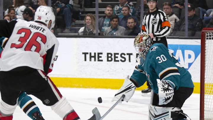 Mar 7, 2020; San Jose, California, USA; San Jose Sharks goaltender Aaron Dell (30) blocks a shot by Ottawa Senators forward Colin White (36) during the first period at SAP Center at San Jose. Mandatory Credit: D. Ross Cameron-Imagn Images