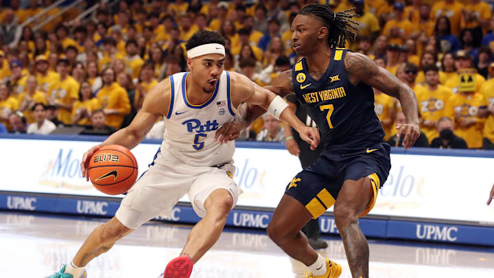Nov 15, 2024; Pittsburgh, Pennsylvania, USA;  Pittsburgh Panthers guard Ishmael Leggett (5) drives to the basket against West Virginia Mountaineers guard Javon Small (7) during the first half at the Petersen Events Center. Mandatory Credit: Charles LeClaire-Imagn Images