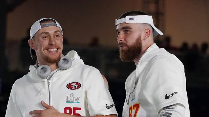 Jan 27, 2020; Miami, FL, USA;  San Francisco 49ers tight end George Kittle (85) greets Kansas City Chiefs tight end Travis Kelce (87) during Super Bowl LIV Opening Night at Marlins Park.  Mandatory Credit: Kirby Lee-Imagn Images