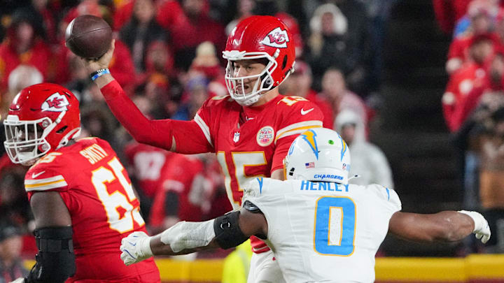 Dec 8, 2024; Kansas City, Missouri, USA; Kansas City Chiefs quarterback Patrick Mahomes (15) throws a pass as Los Angeles Chargers linebacker Daiyan Henley (0) attempts the sack during the second half at GEHA Field at Arrowhead Stadium. Mandatory Credit: Denny Medley-Imagn Images