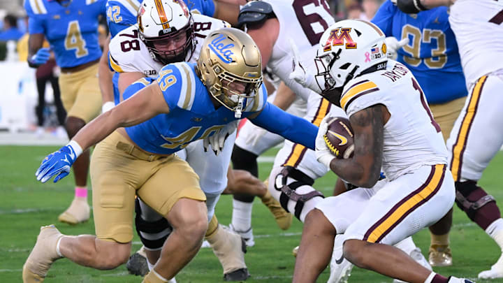 Oct 12, 2024; Pasadena, California, USA; UCLA Bruins linebacker Carson Schwesinger (49) moves to tackle Minnesota Golden Gophers running back Darius Taylor (1) during the first half at Rose Bowl. Mandatory Credit: Robert Hanashiro-Imagn Images Oct 12, 2024; Pasadena, California, USA; UCLA Bruins linebacker Carson Schwesinger (49) moves to tackle Minnesota Golden Gophers running back Darius Taylor (1) during the first half at Rose Bowl. Mandatory Credit: Robert Hanashiro-Imagn Images