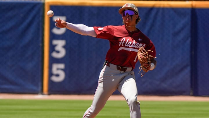 May 21, 2025; Hoover, AL, USA; Alabama shortstop Justin Lebron (1) throws to first but a fielding muff allowed the Tennessee batter to arrive safely in the second round of the SEC Baseball Tournament at the Hoover Met.