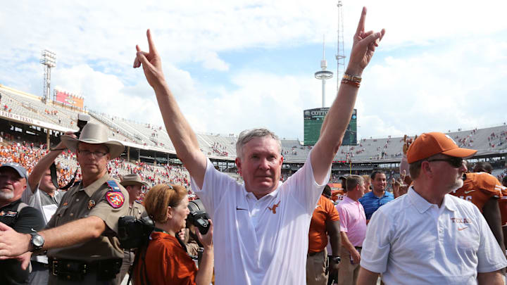 Texas Longhorns head coach Mack Brown celebrates with his team after a victory against the Oklahoma Sooners. Texas Longhorns head coach Mack Brown celebrates with his team after a victory against the Oklahoma Sooners.