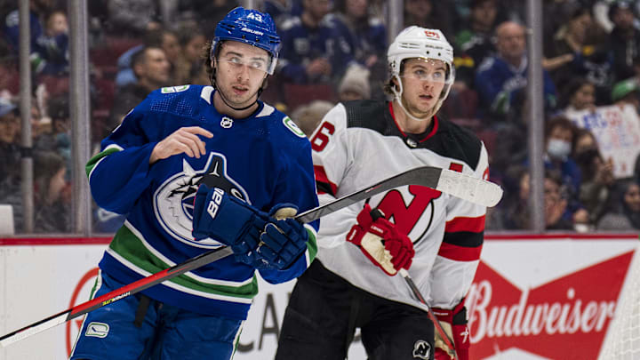 Mar 15, 2022; Vancouver, British Columbia, CAN; Vancouver Canucks defenseman Quinn Hughes (43) shares laugh with his brother New Jersey Devils forward Jack Hughes (86) in the second period at Rogers Arena. Mandatory Credit: Bob Frid-Imagn Images