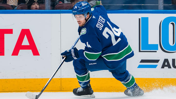 Mar 11, 2025; Vancouver, British Columbia, CAN; Vancouver Canucks forward Pius Suter (24) handles the puck against the Montreal Canadiens in the first period at Rogers Arena. Mandatory Credit: Bob Frid-Imagn Images