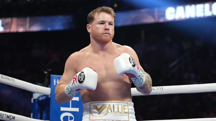May 7, 2022; Las Vegas, Nevada, USA; Canelo Alvarez (pink trunks) and Dimitry Bivol (black trunks) box during their light heavyweight championship bout at T-Mobile Arena. Mandatory Credit: Joe Camporeale-Imagn Images