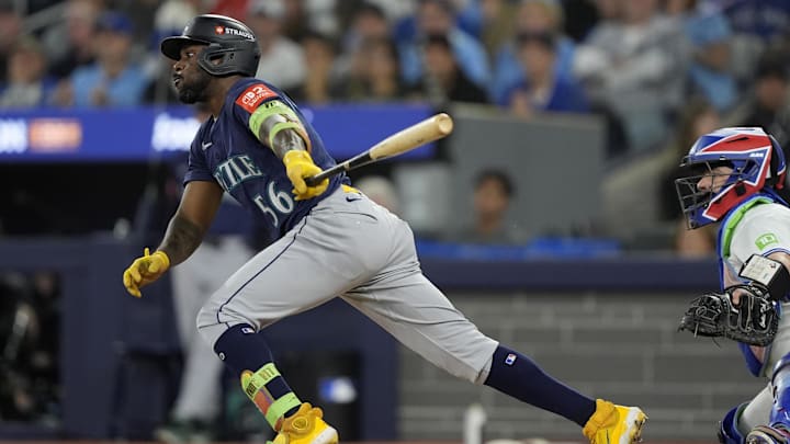Oct 20, 2025; Toronto, Ontario, CAN; Seattle Mariners left fielder Randy Arozarena (56) hits a single against the Toronto Blue Jays in the second inning during game seven of the ALCS round for the 2025 MLB playoffs at Rogers Centre. Mandatory Credit: John E. Sokolowski-Imagn Images