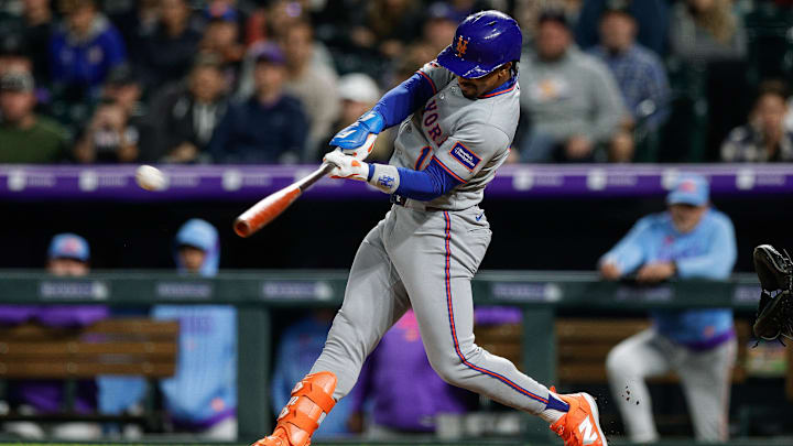 Jun 6, 2025; Denver, Colorado, USA; New York Mets pinch hitter Francisco Lindor (12) hits a two RBI double in the ninth inning against the Colorado Rockies at Coors Field. Mandatory Credit: Isaiah J. Downing-Imagn Images