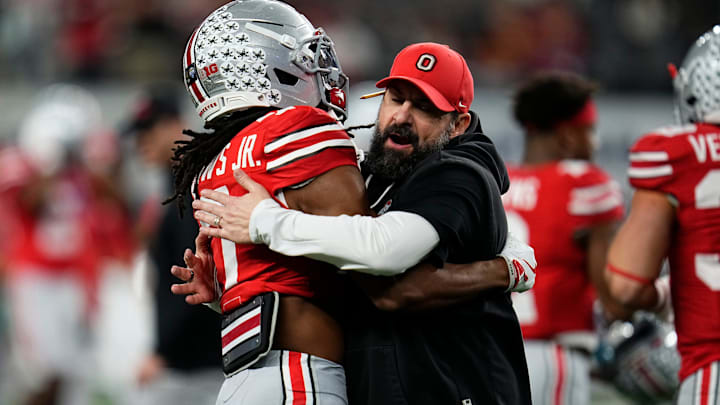 Ohio State Buckeyes defensive coordinator Matt Patricia hugs cornerback Jermaine Mathews Jr. (7) during warm-ups prior to the Cotton Bowl at AT&T Stadium in Arlington, Texas for the College Football Playoff quarterfinal game against the Miami Hurricanes on Dec. 31, 2025.