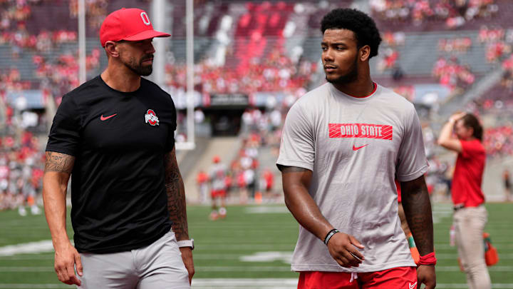 Aug 31, 2024; Columbus, OH, USA; Ohio State Buckeyes linebackers coach James Laurinaitis talks to linebacker C.J. Hicks (11) prior to the NCAA football game against the Akron Zips at Ohio Stadium. Ohio State won 52-6.